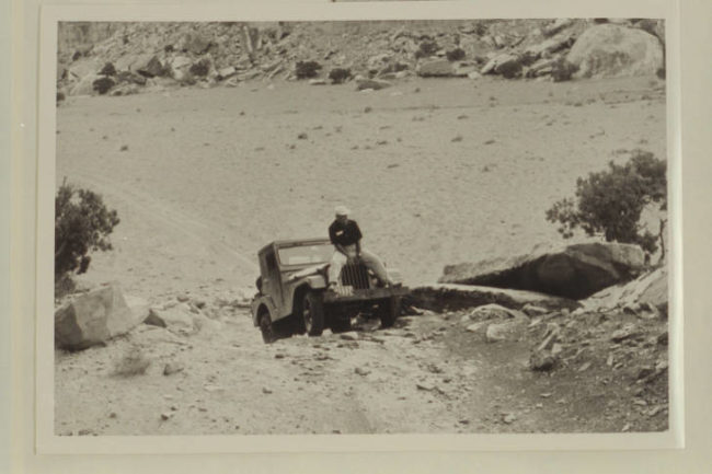 CREDIT: None given .... Caption: Marston rides the hool of Kent Frost's jeep. Needles country, Utah. DATE: Oct. 1955